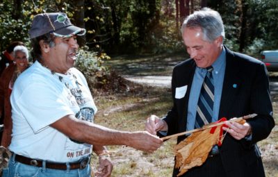 John "Blackfeather" Jeffris, Occaneeci-Saponi chief, left, presents an arrow and "hand" of tobacco to UNC-CH Chancellor Michael Hooker during a stop at the Occaneechi Village Site in Hillsboro. The stop was part of the chancellor's tour of Orange County.